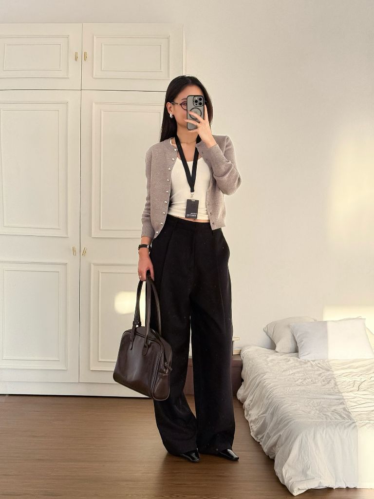 Grey cardigan over white tank with black wide-leg trousers and brown bag, mirror selfie