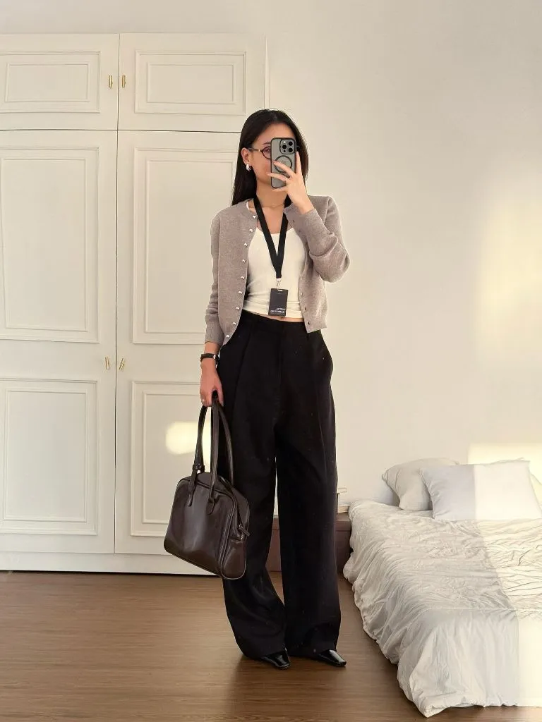 Grey cardigan over white tank with black wide-leg trousers and brown bag, mirror selfie