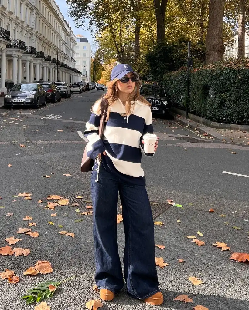 Navy and cream striped rugby shirt with wide-leg jeans and brown boots in London