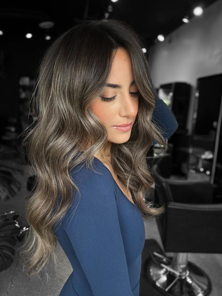 Dark cool-toned balayage melting into smoky silver-blonde waves