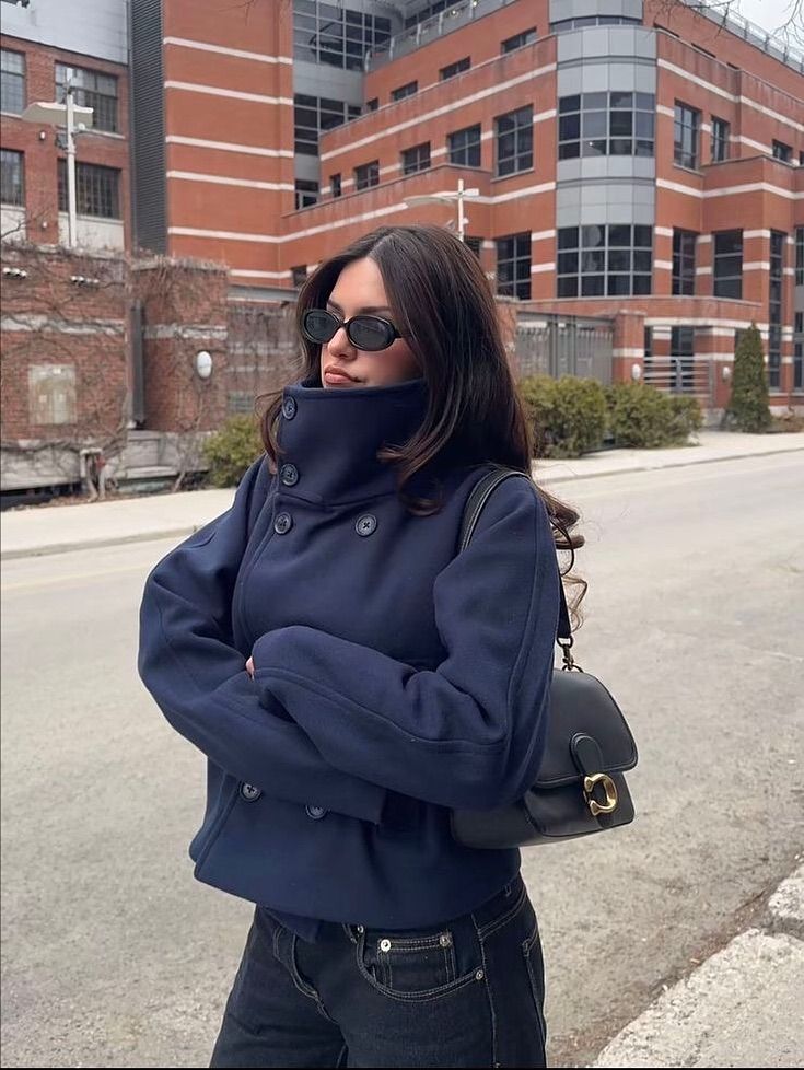 Dark navy funnel neck peacoat with dark jeans and crossbody bag