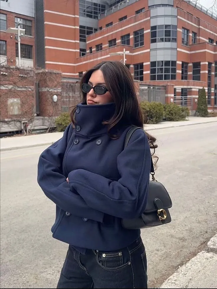 Dark navy funnel neck peacoat with dark jeans and crossbody bag
