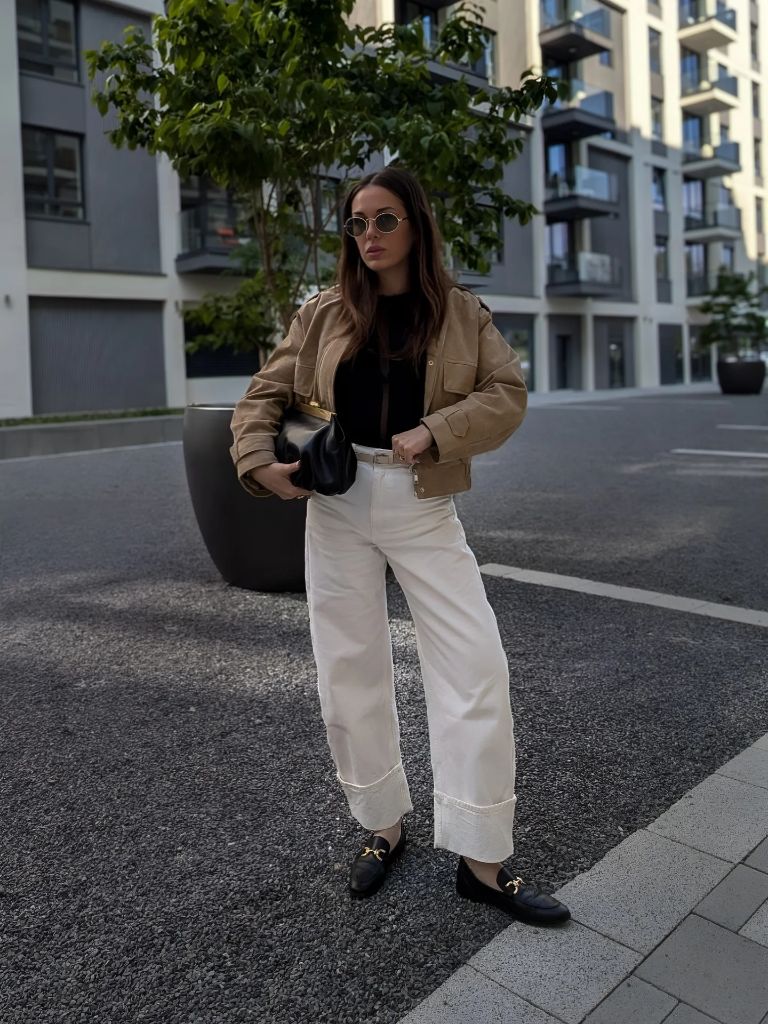 Tan cropped jacket with white wide-leg trousers and loafers