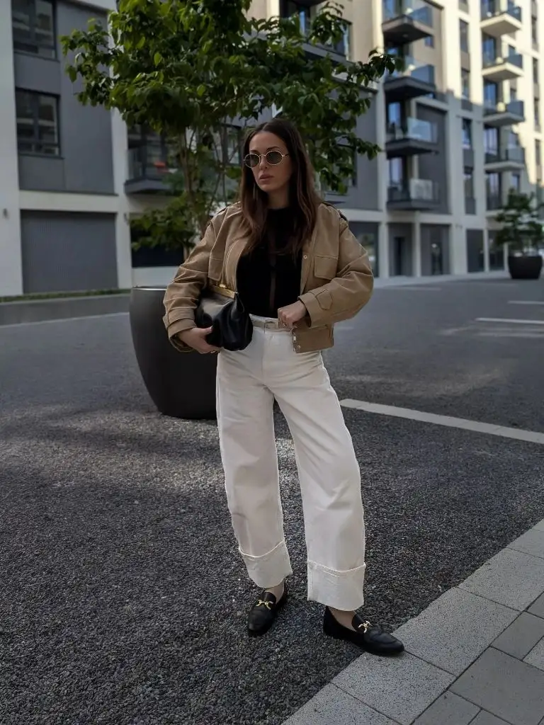 Tan cropped jacket with white wide-leg trousers and loafers