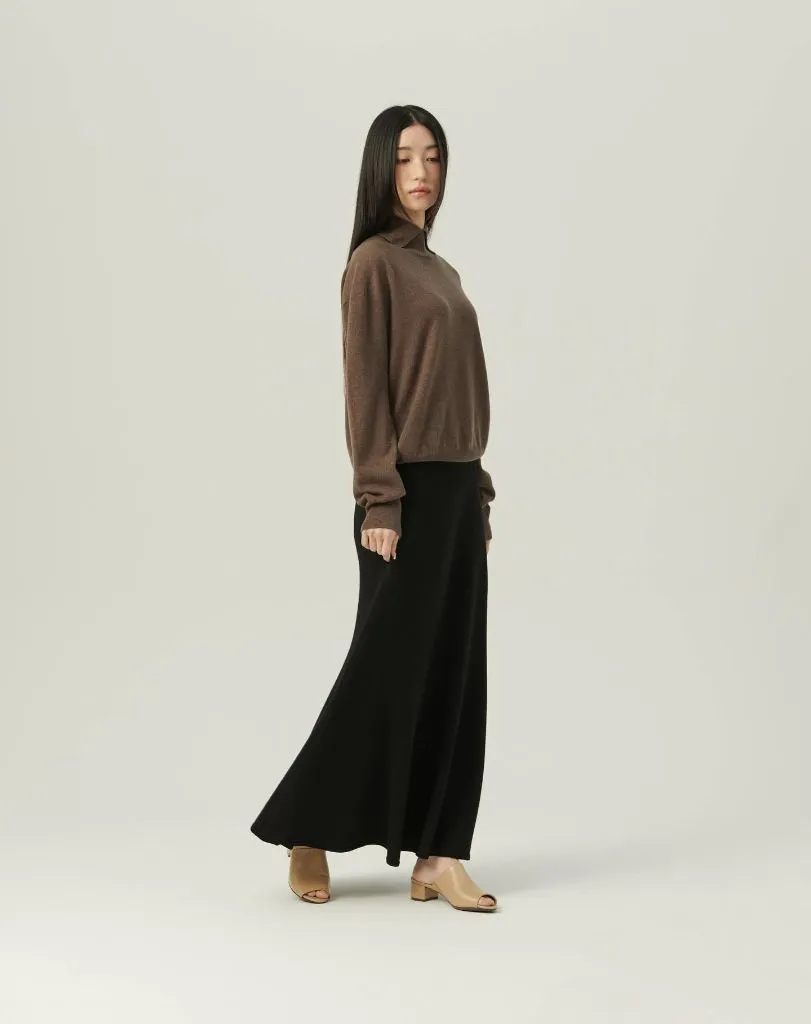 Black knit maxi skirt with brown crewneck sweater and tan mules