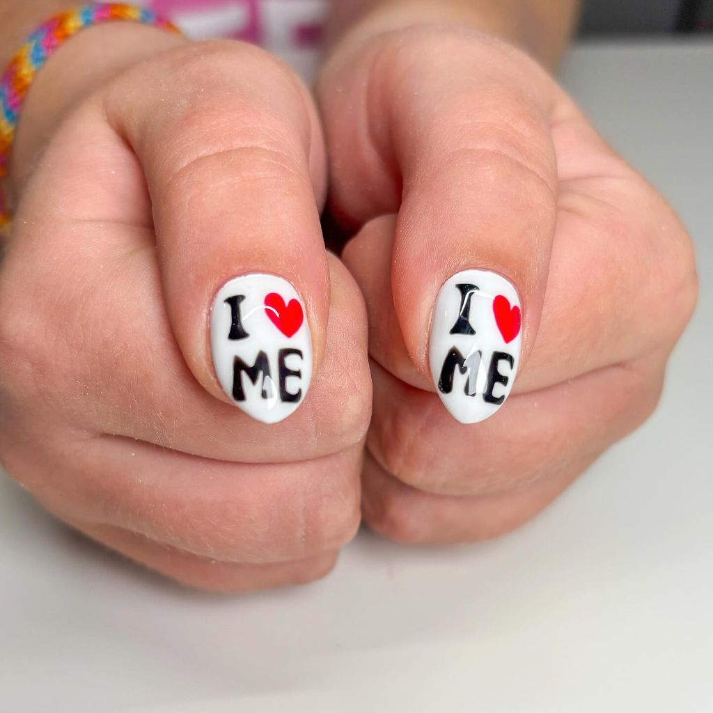 I love me text nail art with red hearts on short white nails August nails color 2026 ideas