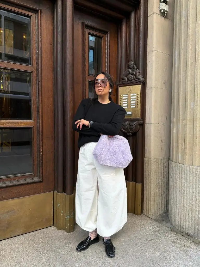 Black sweater and white pants
