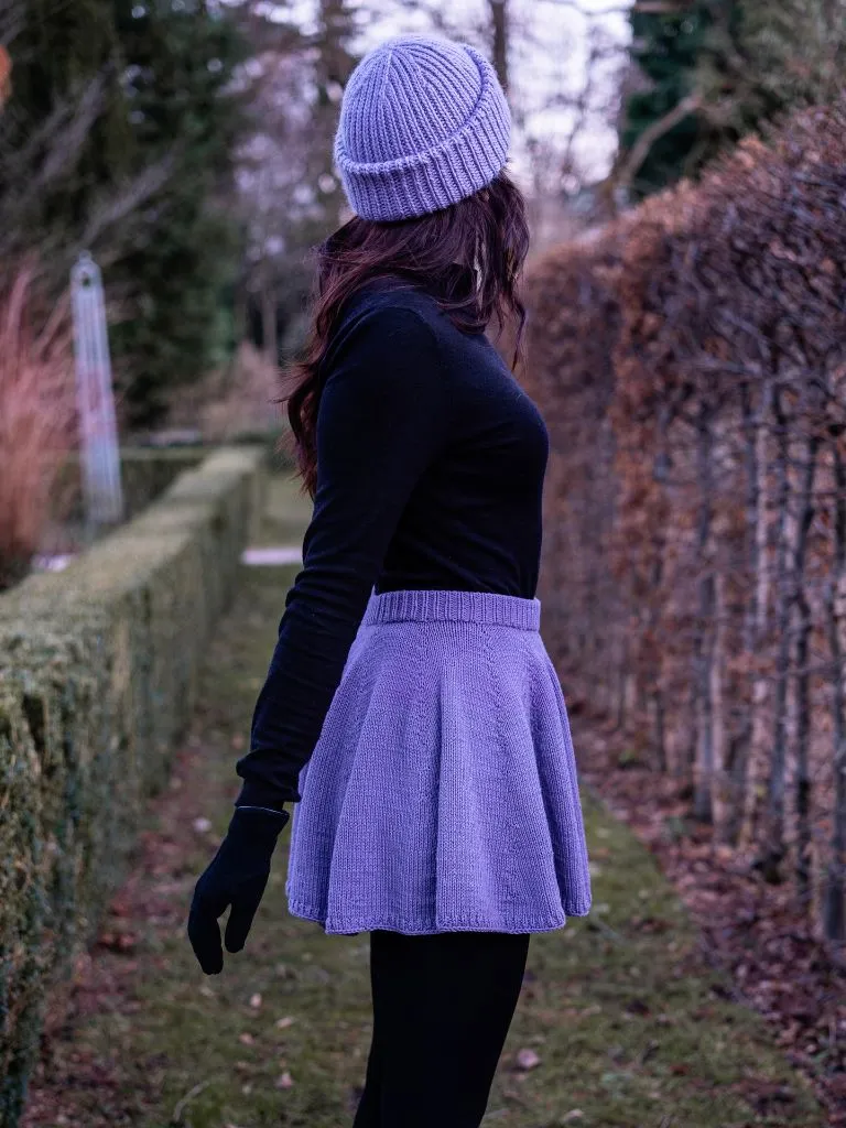 Lavender knit skater skirt with black turtleneck and matching beanie