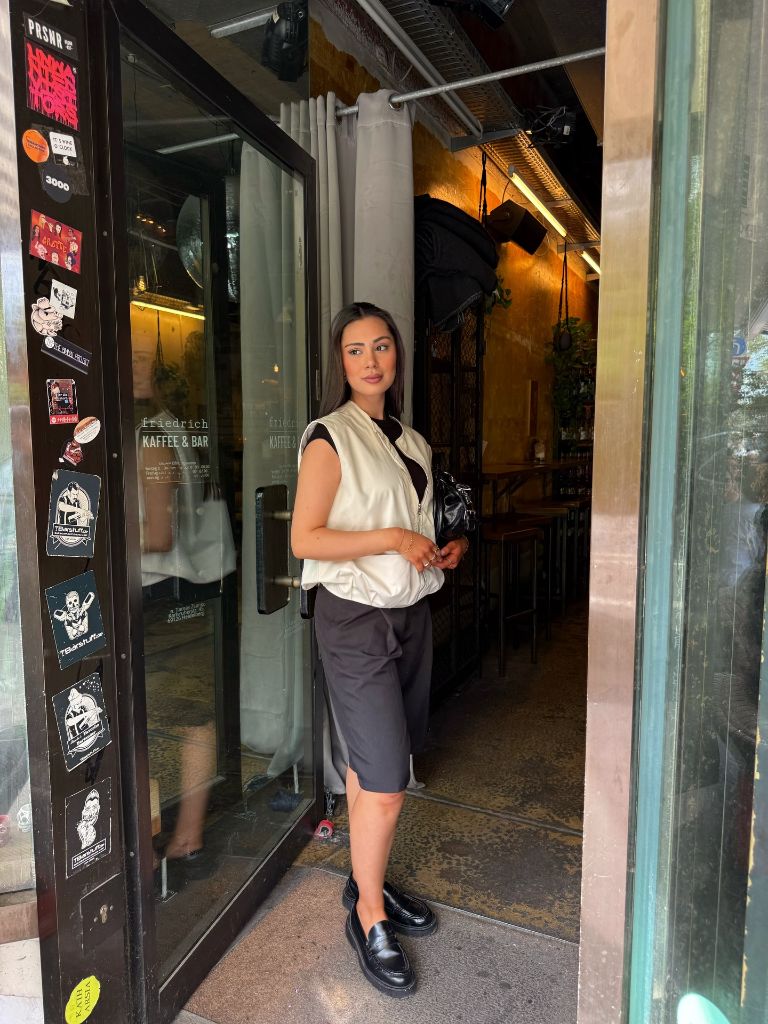 White vest and gray bermuda shorts
