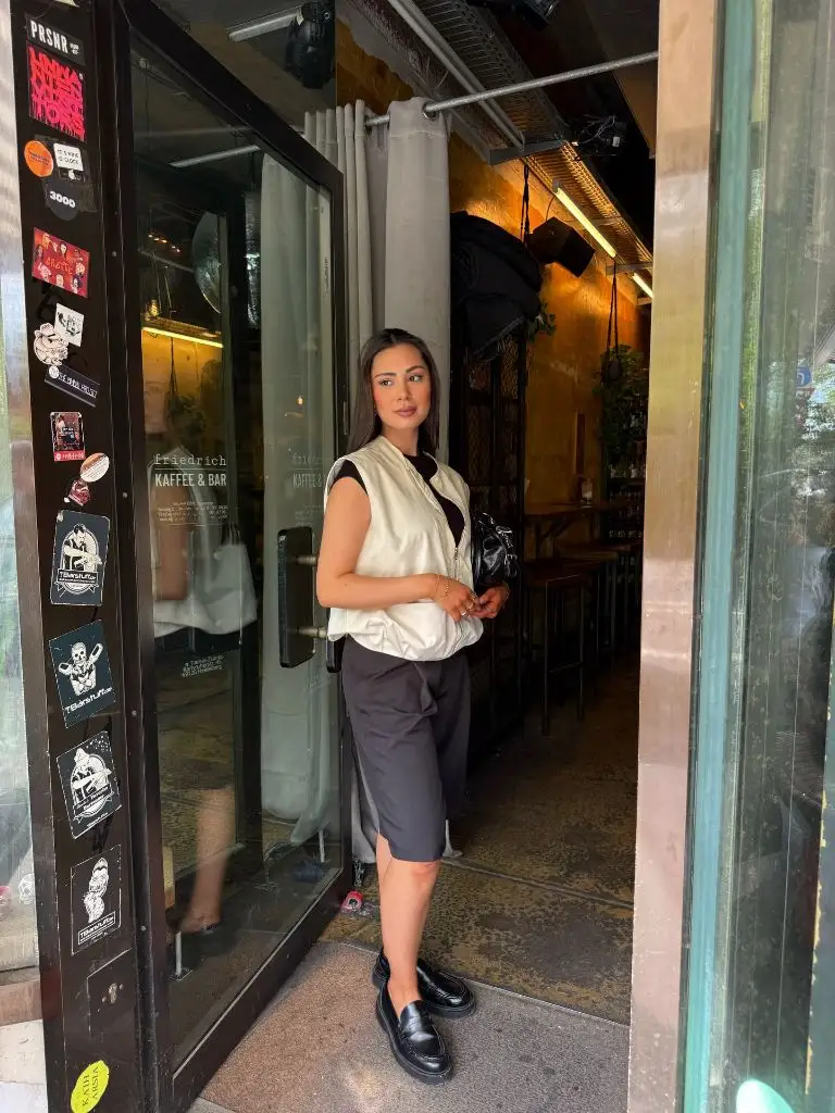 White vest and gray bermuda shorts