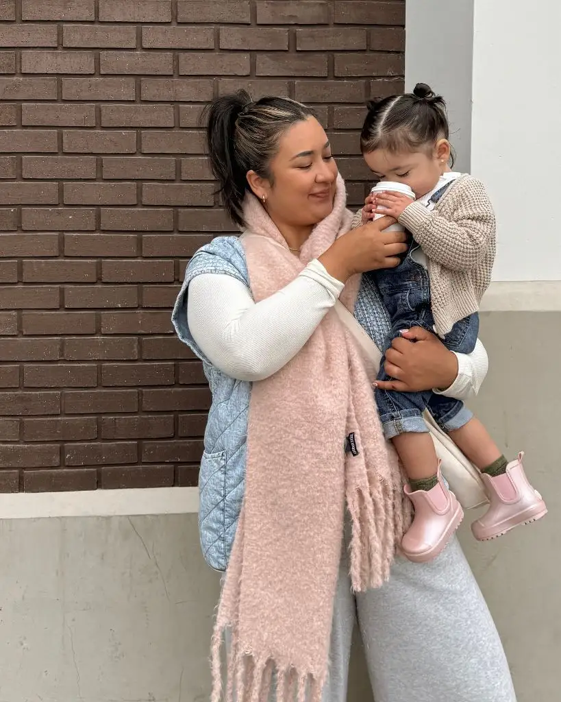 Fall mom outfit with pink scarf and quilted vest