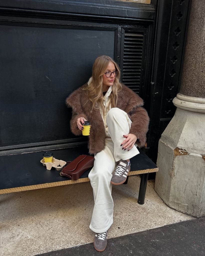 Brown fuzzy jacket with cream joggers and grey Adidas Sambas