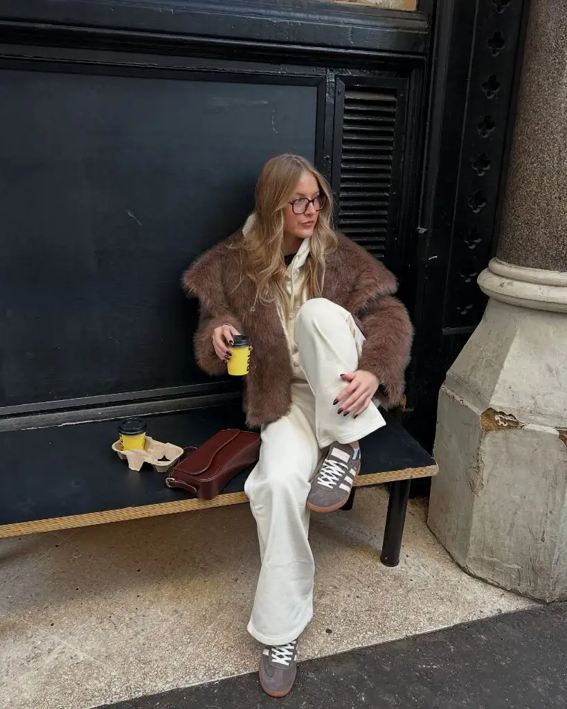 Brown fuzzy jacket with cream joggers and grey Adidas Sambas