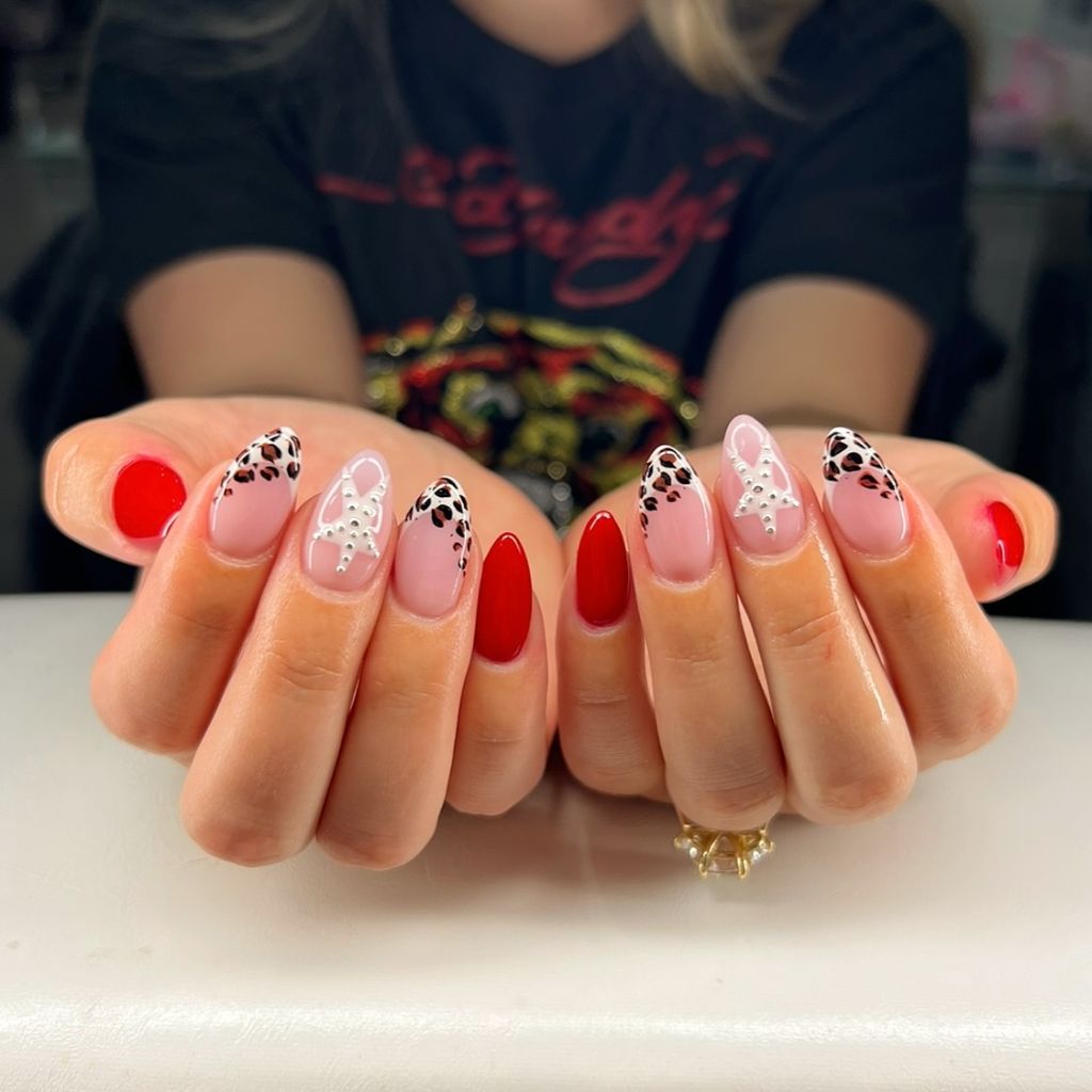 Red and leopard print almond nails with pearl bow accents for August 2026