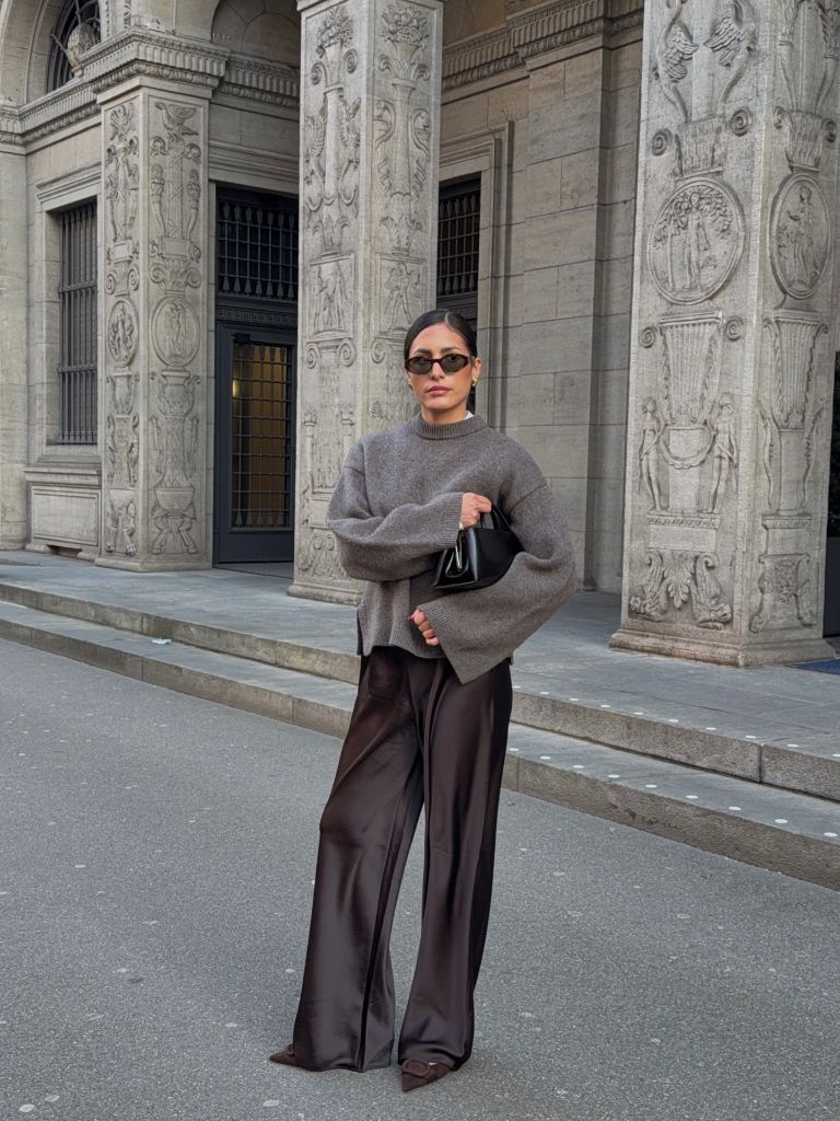 Fall professional outfit grey crewneck sweater chocolate satin wide-leg trousers black bag