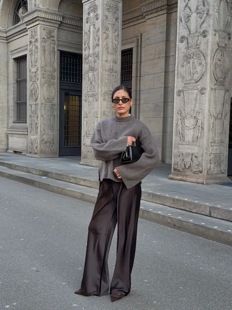 Fall professional outfit grey crewneck sweater chocolate satin wide-leg trousers black bag