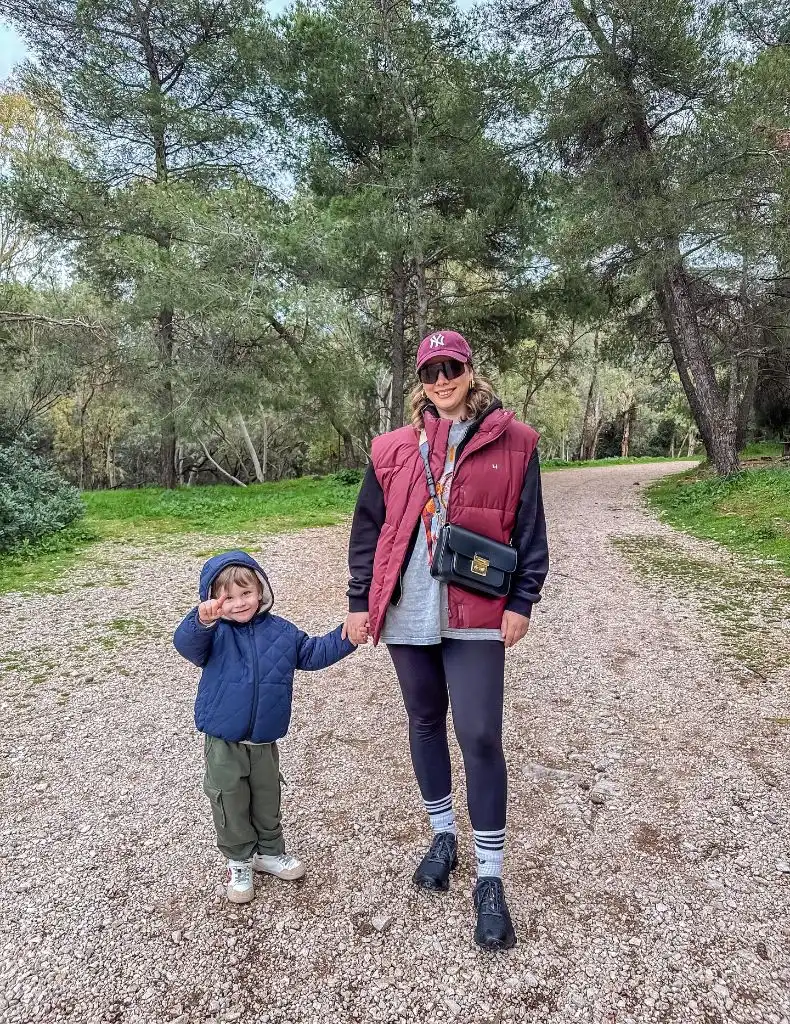 Mom and child on nature trail wearing puffer vest and leggings
