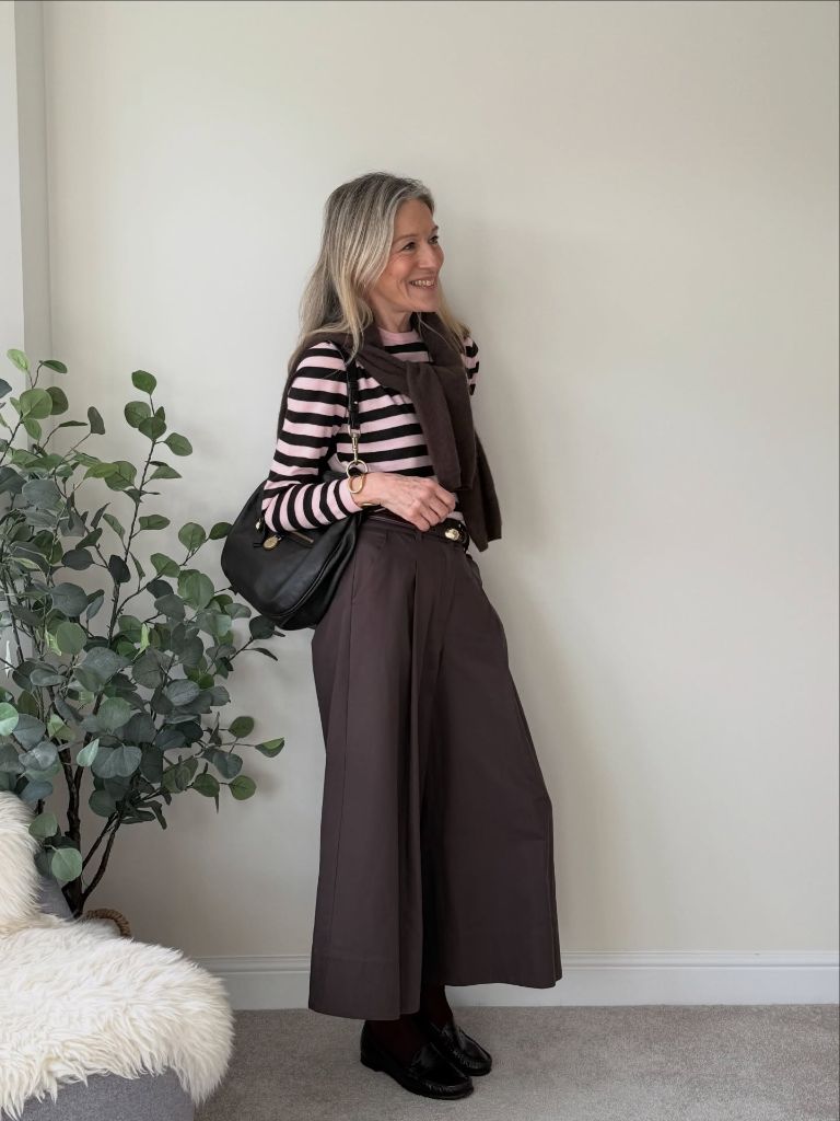 Pink and dark brown striped top with wide brown trousers and loafers
