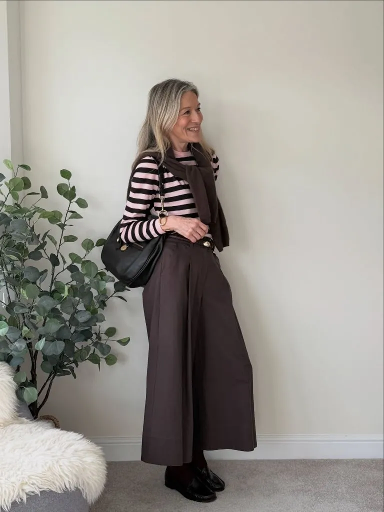 Pink and dark brown striped top with wide brown trousers and loafers