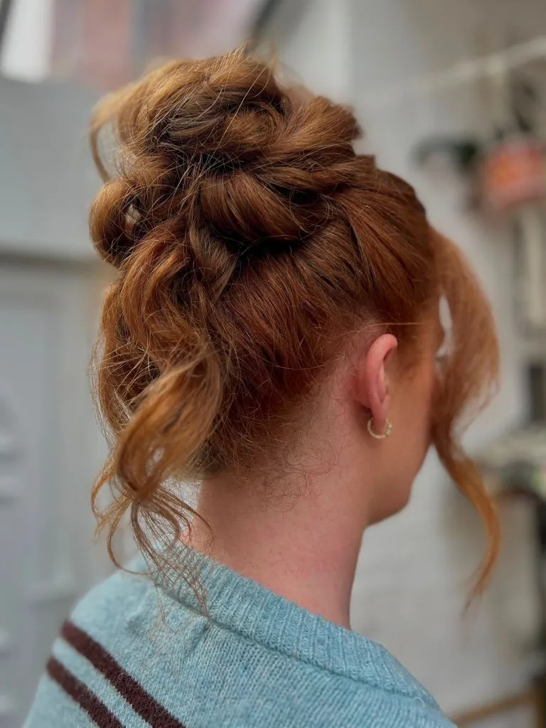 Fall Hairstyles for Office 2026 Tousled Textured High Bun with Natural Curls