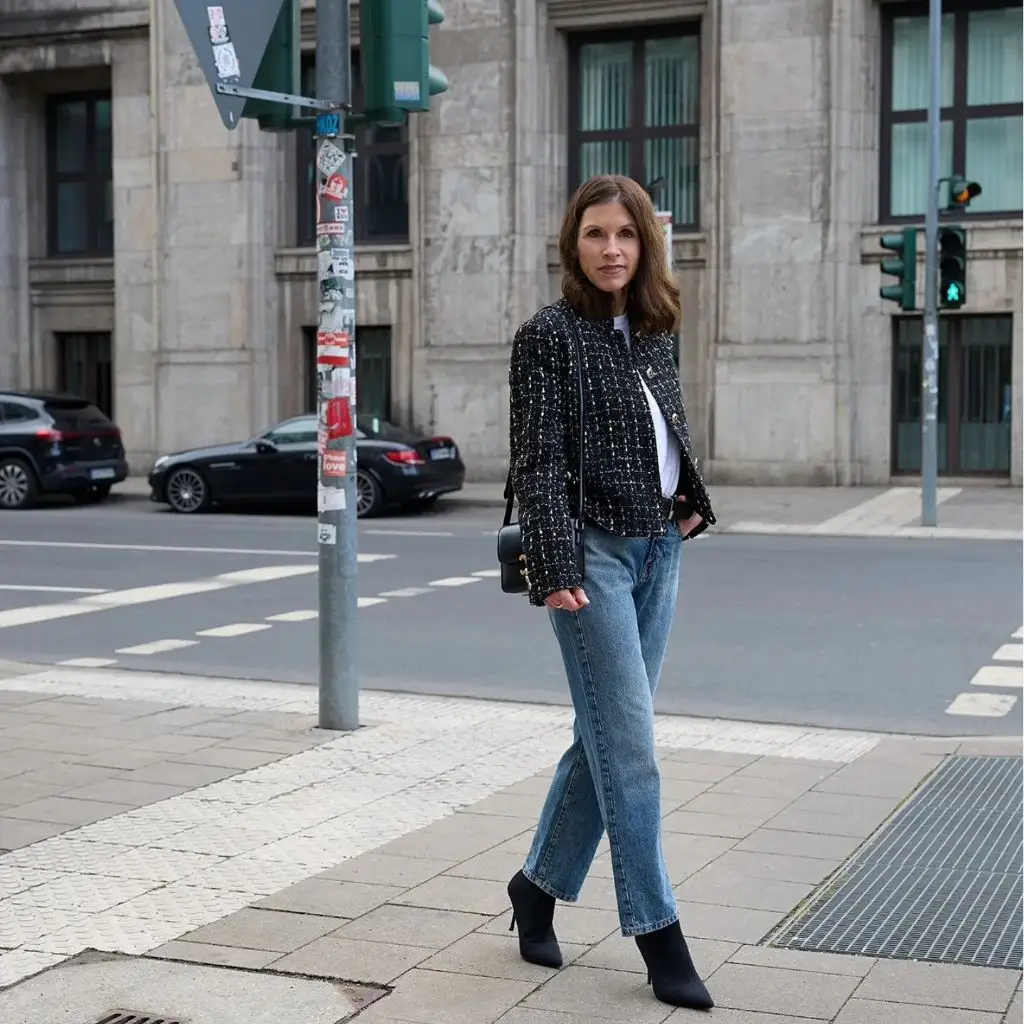 Black tweed jacket with white tee and straight-leg jeans