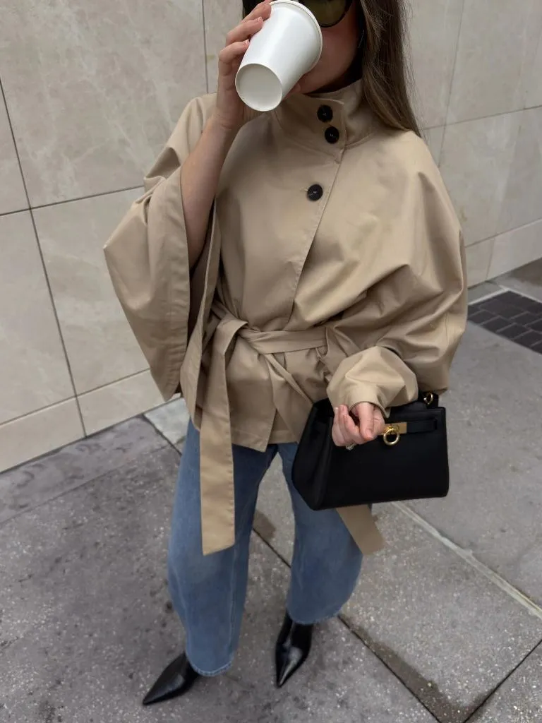 Beige cape-style belted peacoat with jeans and pointed boots