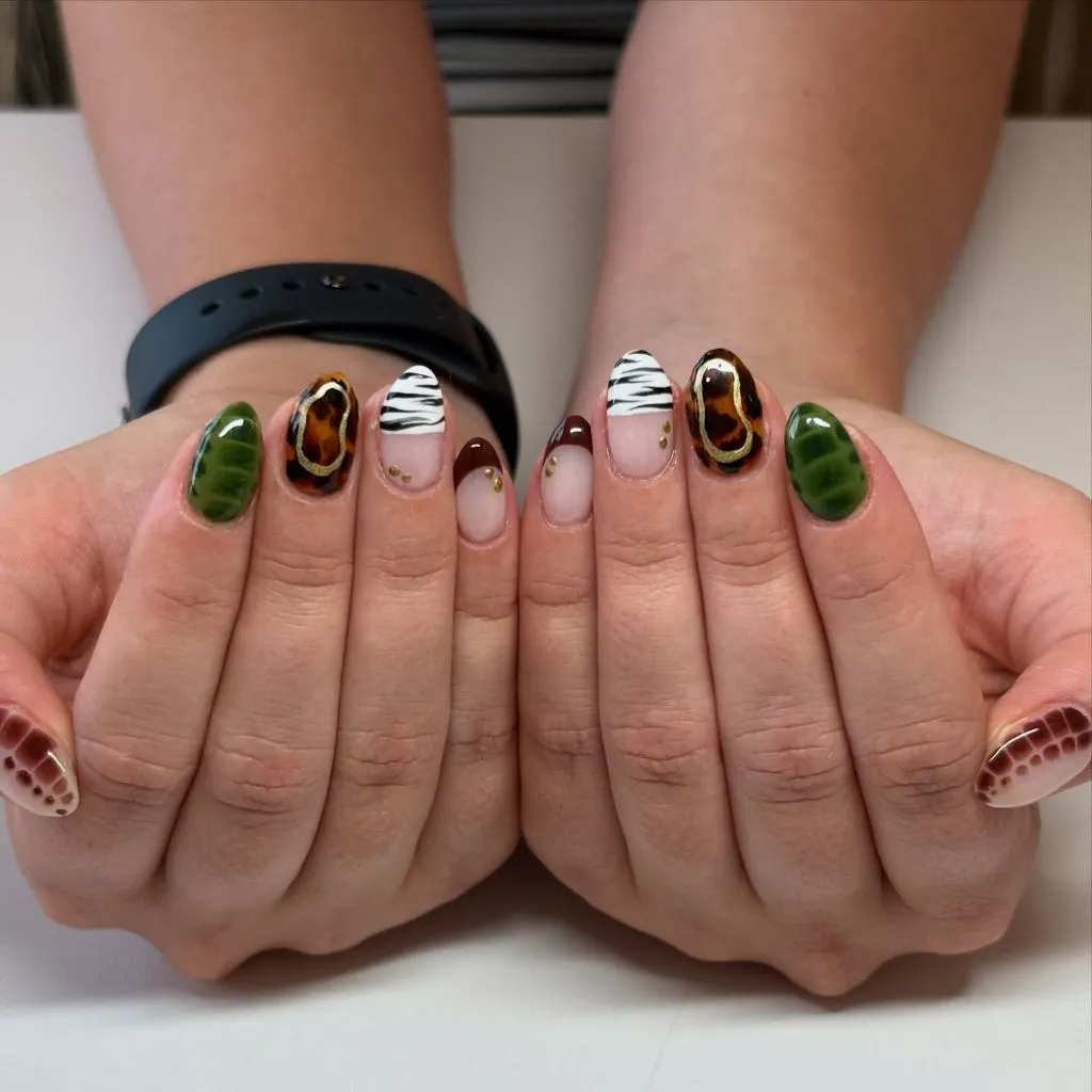 Safari themed nails with green croc print, tortoiseshell, and zebra stripes, August nails ideas 2026