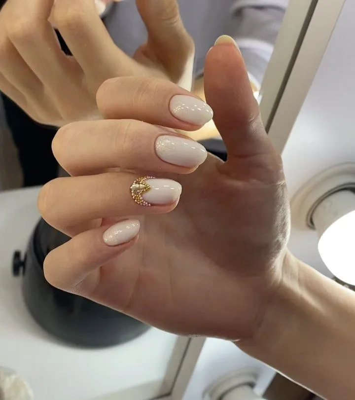 Fall Wedding Nails 2026 Milky White With Gold Caviar Bead Accent On Short Oval Nails