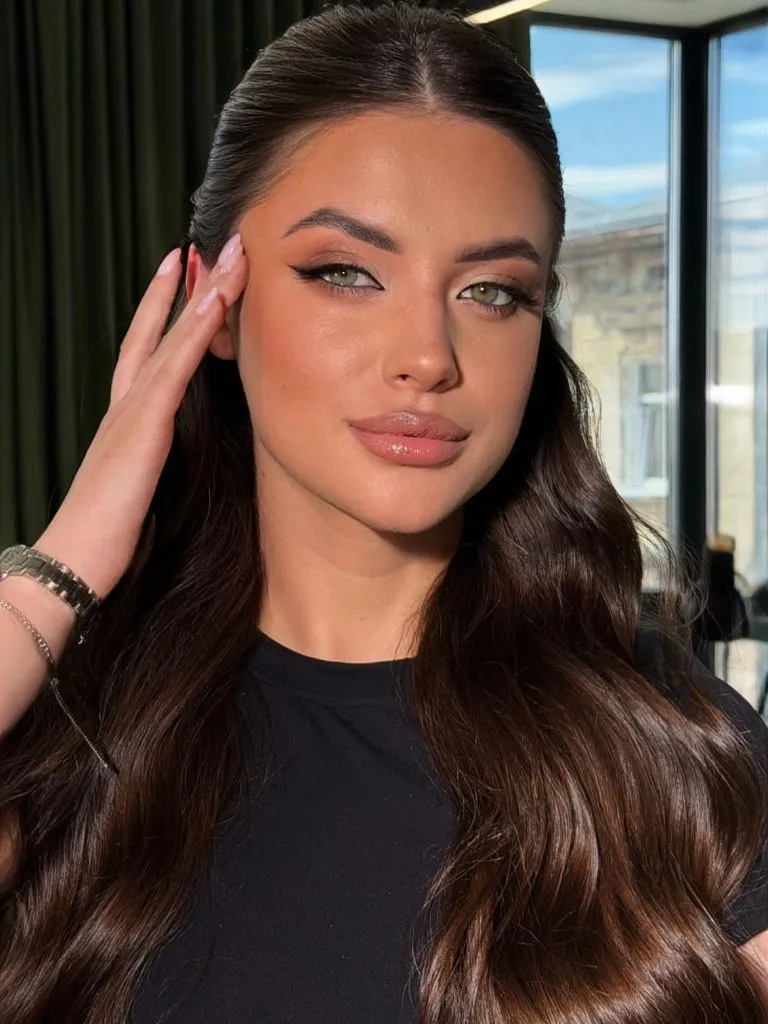 Middle Parting Hairstyles Polished Brunette Waves With Cat-Eye Liner And A Centre Part