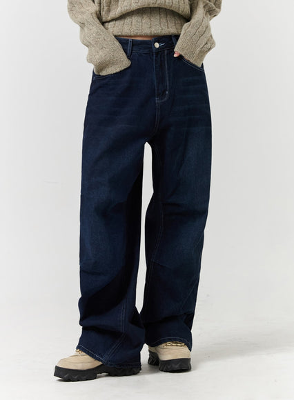 Oatmeal chunky knit sweater tucked into dark wide-leg jeans with chunky loafers
