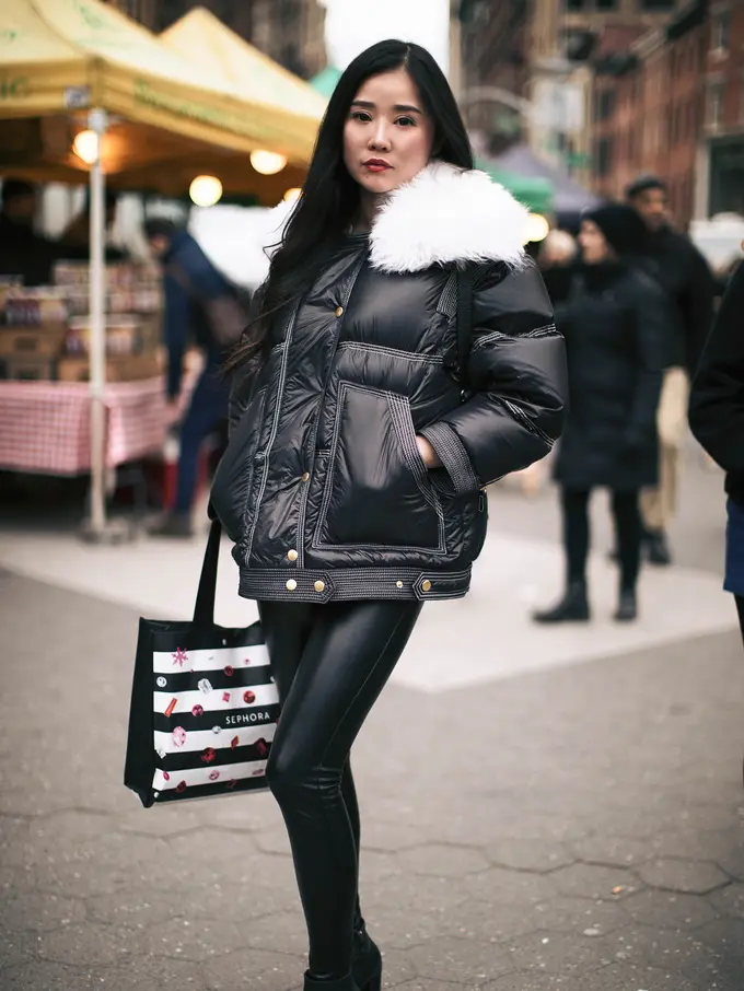 Woman in an all-black athleisure outfit with black leggings and a fitted top