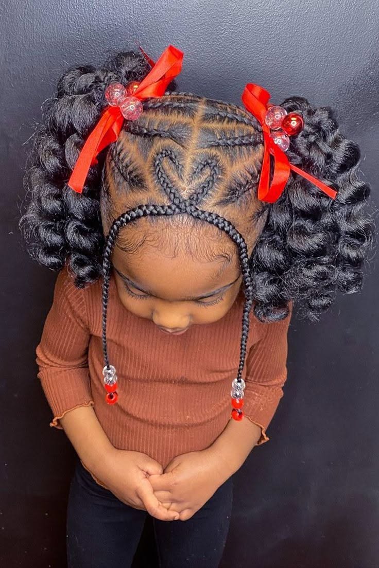 Heart-shaped cornrow parting with curly pigtails, red ribbons and red beads
