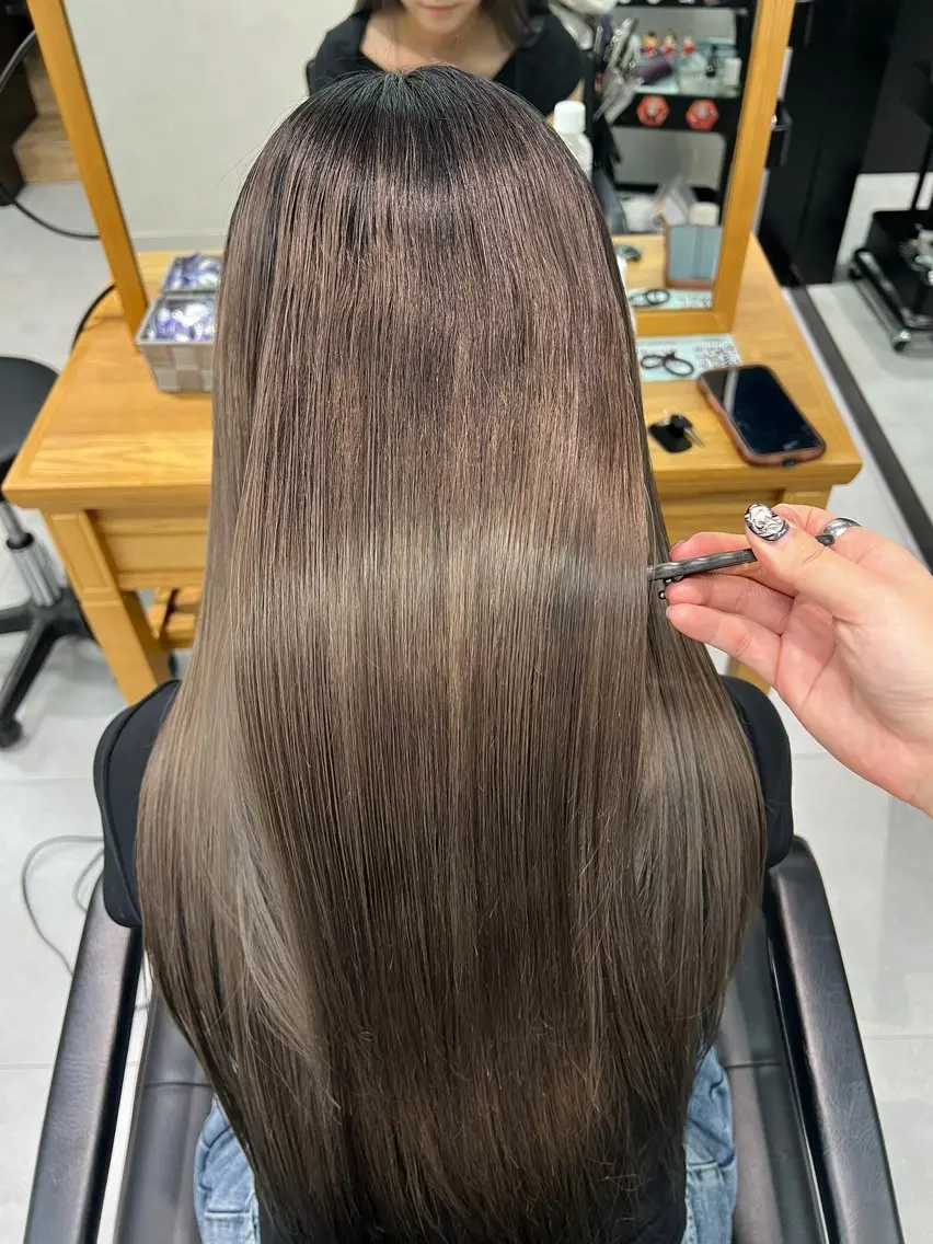 Long straight ash brown hair with darker root shadow