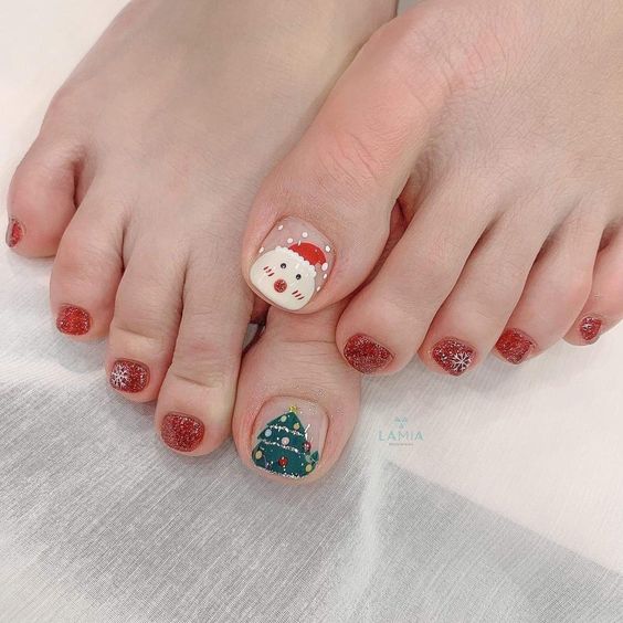 Red glitter pedicure with Santa face on the big toe and Christmas tree art