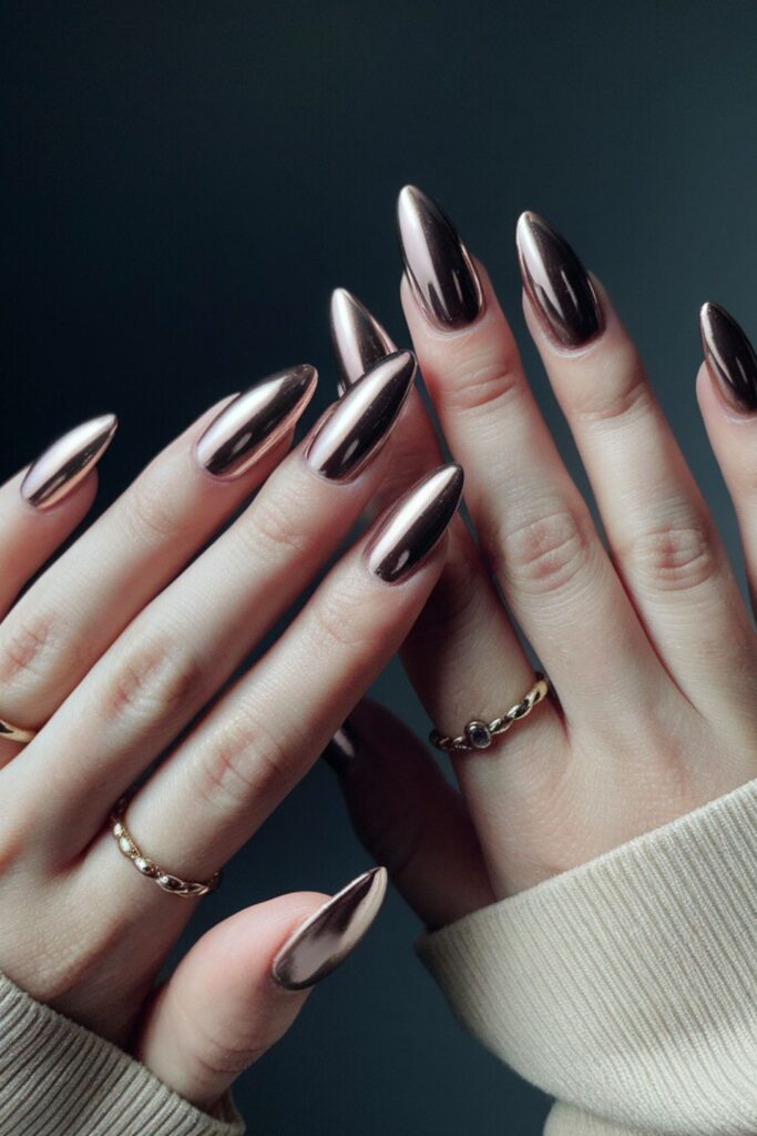 Rose gold chrome almond nails with a mirror-like metallic finish
