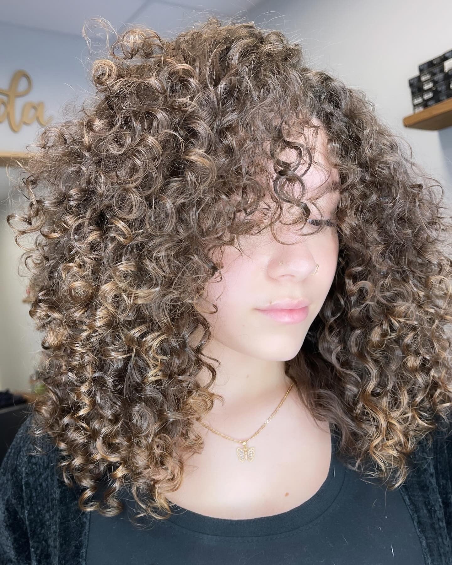 Voluminous ash brown curly layered haircut