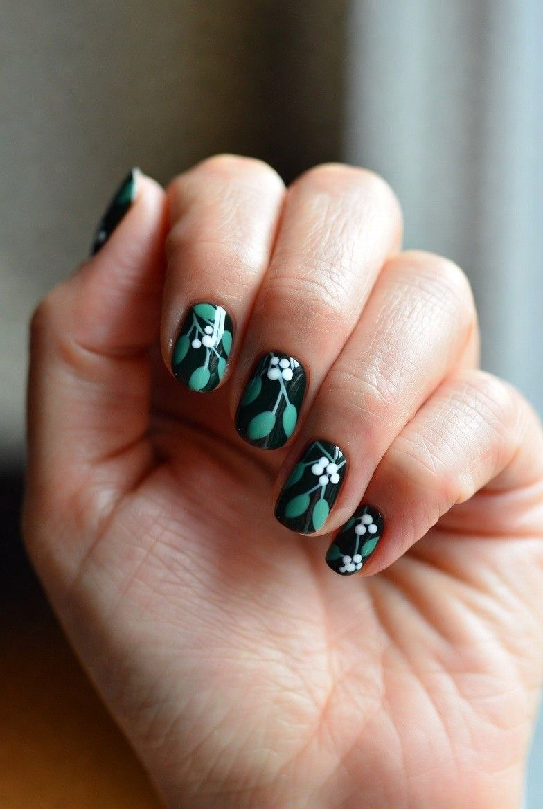 Deep green oval nails with painted mistletoe leaves and white berries