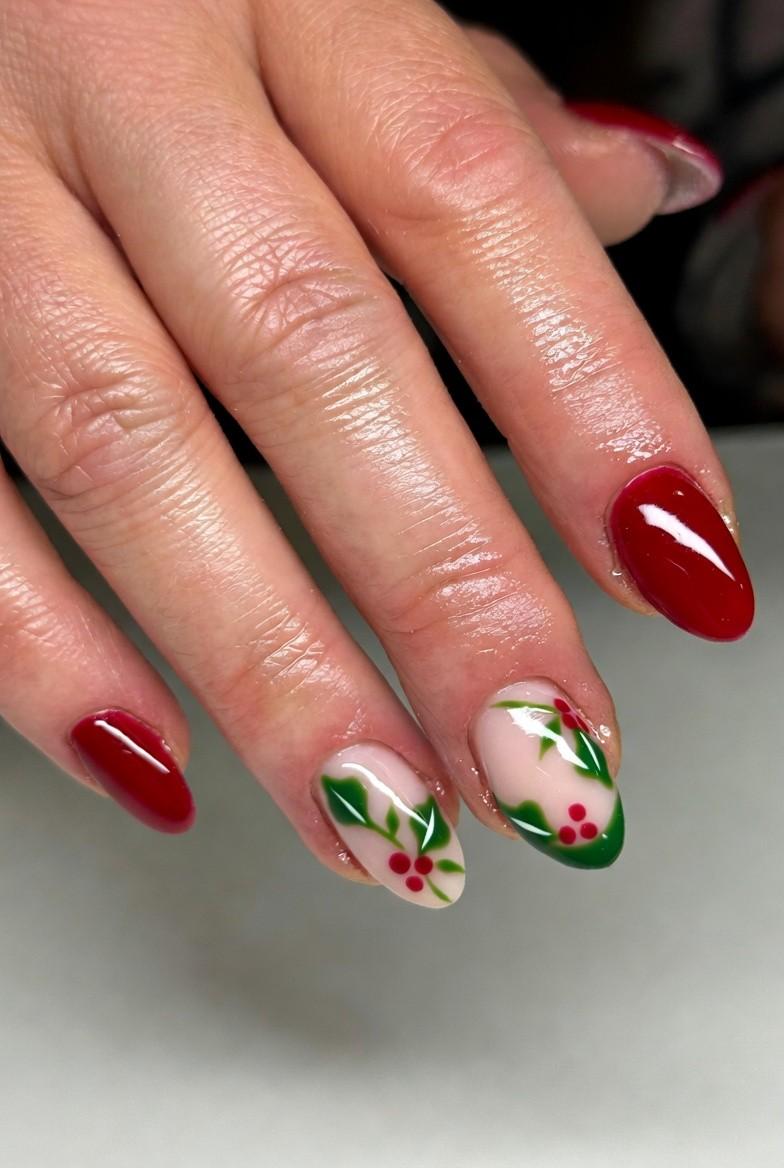 Deep green gel nails with hand-painted red holly berry accents