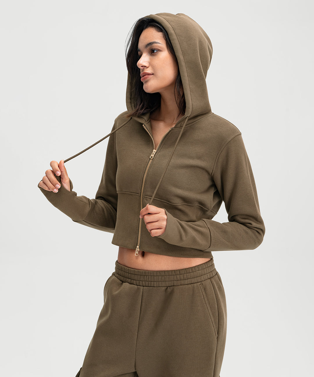 Woman wearing a cropped full-zip hoodie with leggings