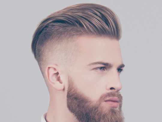 Man with a short pompadour haircut and high fade