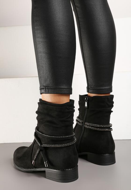 Close-up of black flat slouchy boots with a wrinkled shaft