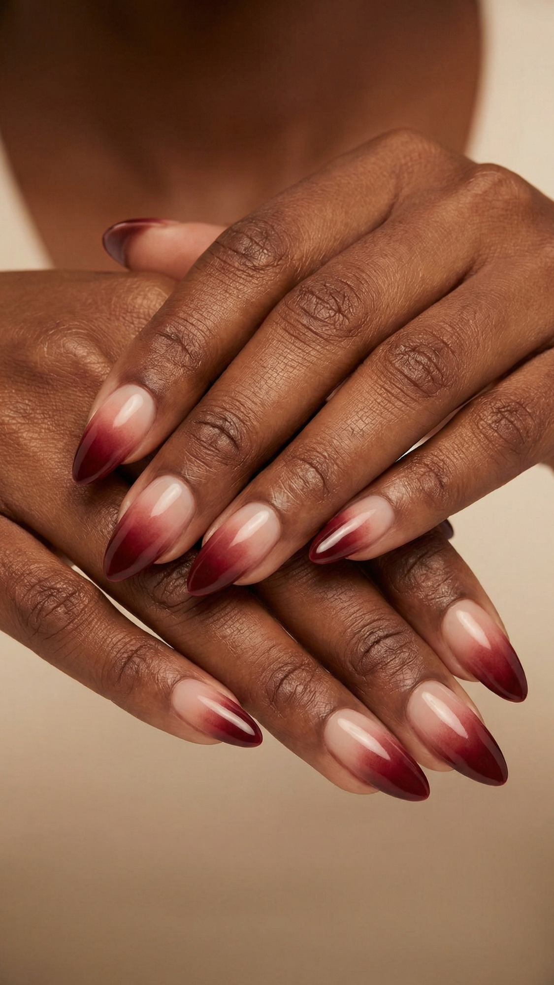 Almond nails with burgundy to nude ombre gradient, dark at the tips