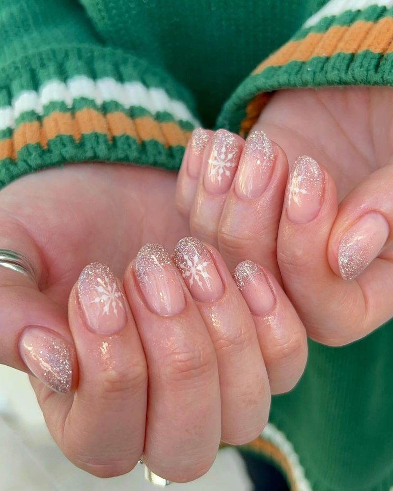 Short almond nails with silver glitter ombré and snowflake detail