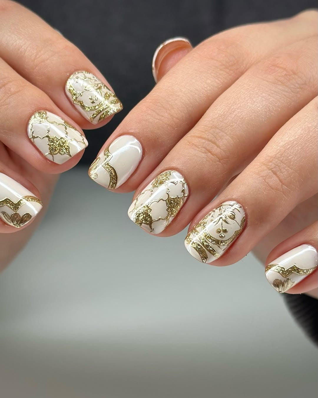 White almond tips manicure with gold foil sweep accents
