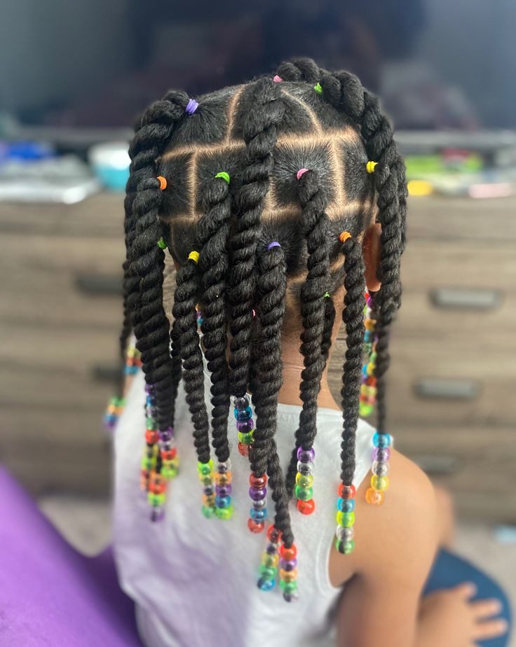 Black child with shoulder-length two-strand twists and colorful beads