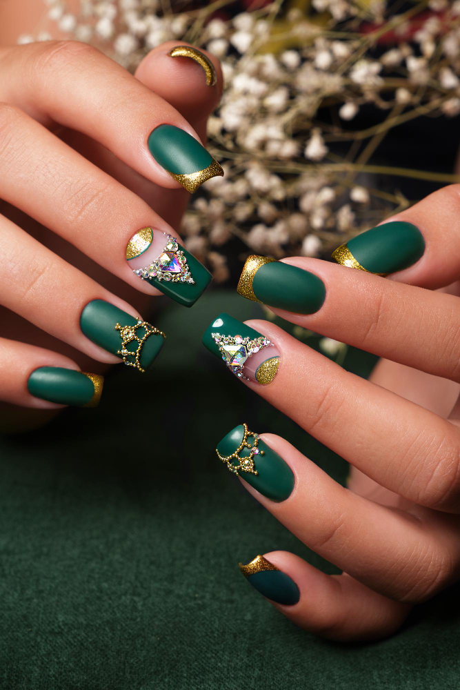 Medium square emerald nails with gold glitter tips and crystal cuticle accents