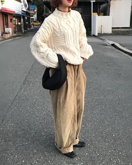 White chunky knit sweater with tan corduroy trousers