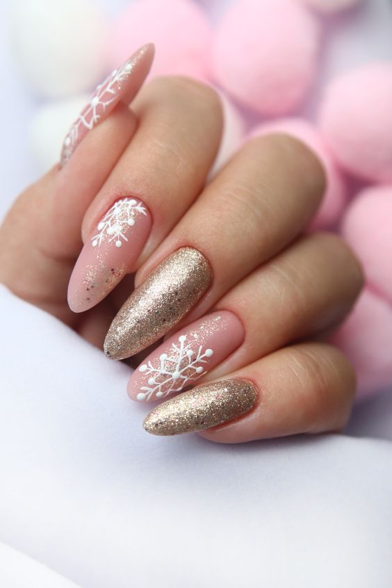 Long almond winter nails with pink glitter French tips and snowflakes