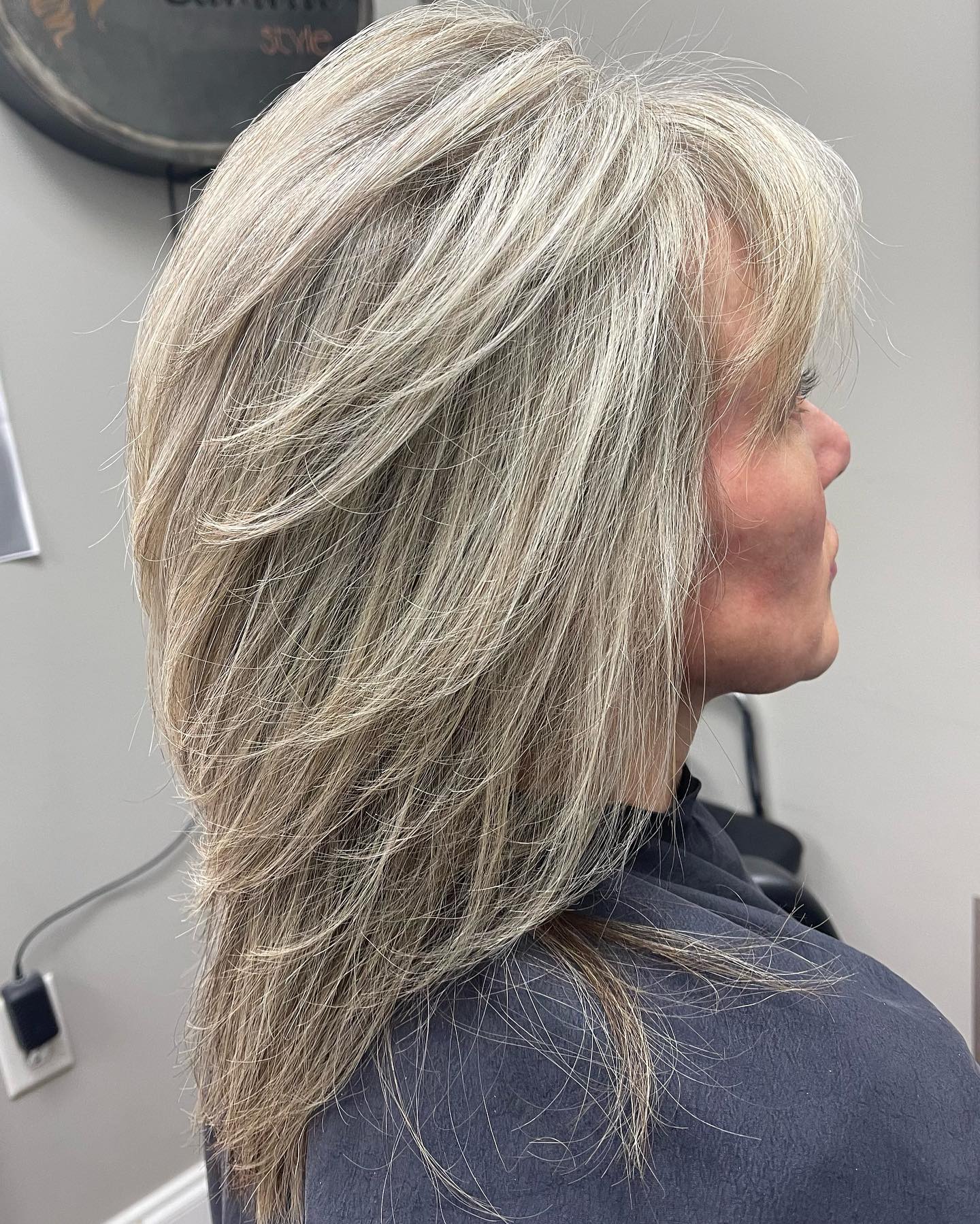 Straight shoulder length silver haircut on an older woman