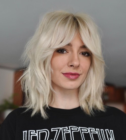 Platinum blonde wolf cut with curtain bangs